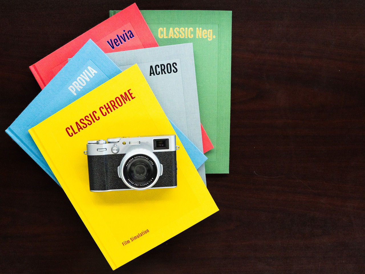 Fujifilm X100 series camera on Fujifilm film simulation books