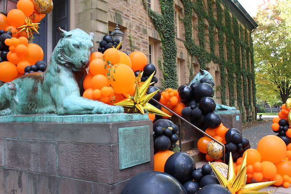 Bronze tigers outside Nassau Hall with orange, black, and gold balloons