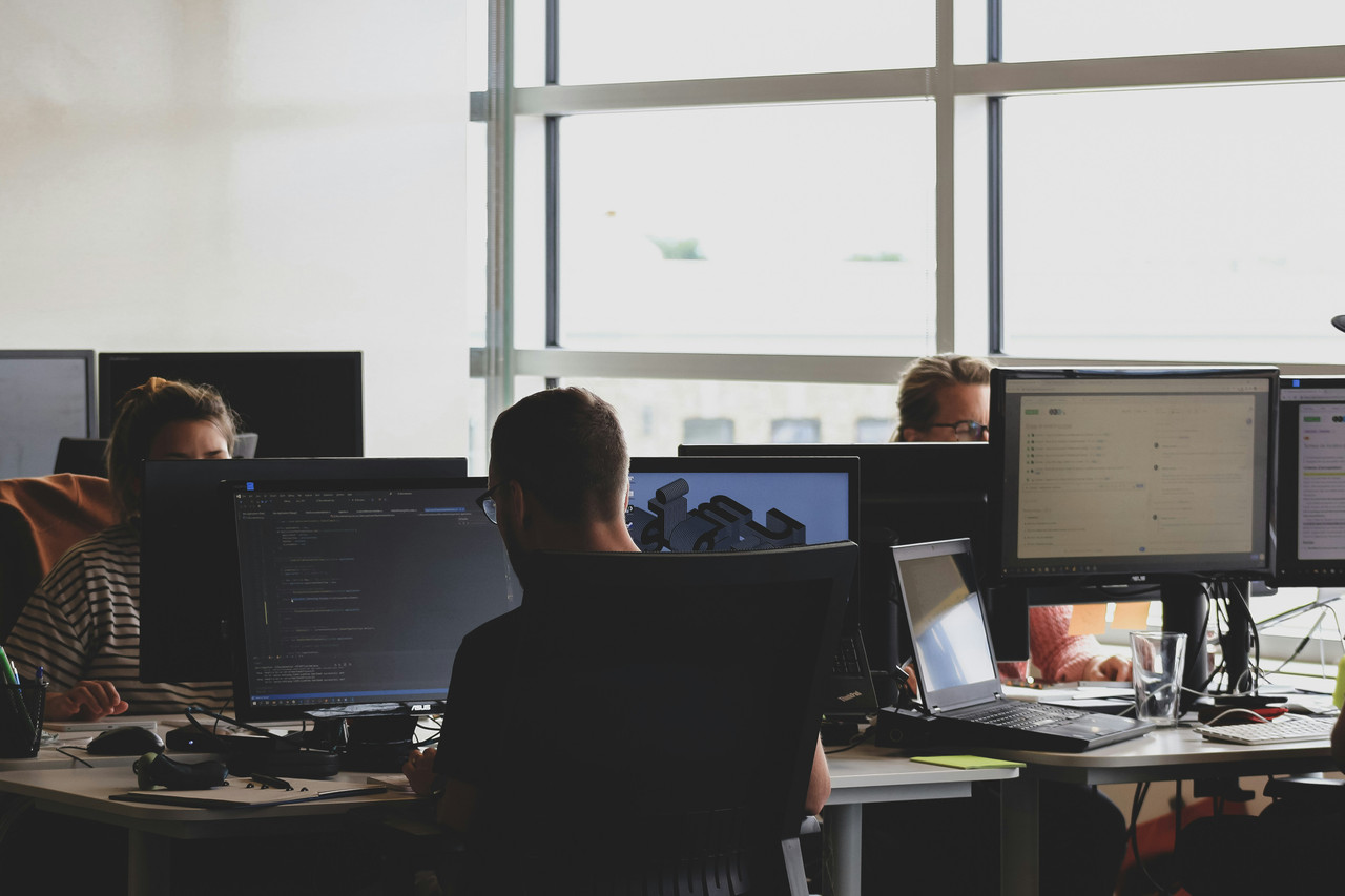 Engineers analyzing code on a laptop screen