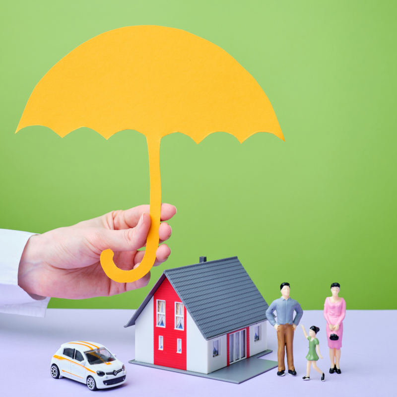 An umbrella held over a family's home