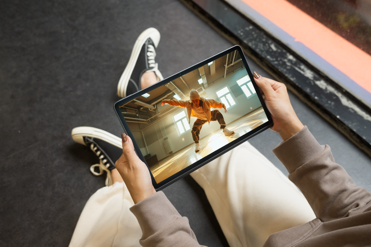 A person holding a tabletDescription automatically generated A person holding a tabletDescription automatically generated