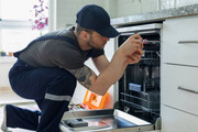 Technician fixing oven
