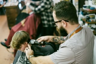 A young boy getting a haircut