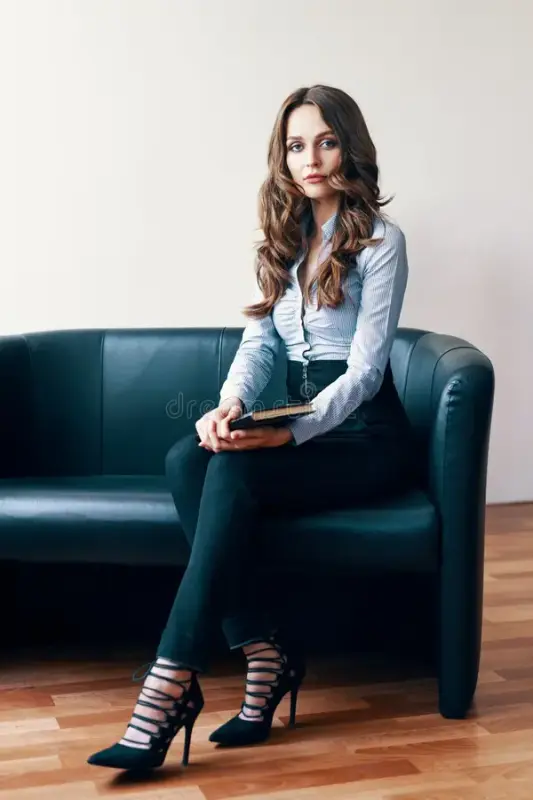 portrait-beautiful-female-psychologist-sitting-couch-smiling-to-camera-179004325