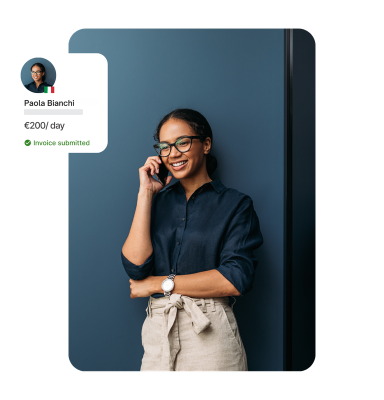 Two women posing at an office work area with warm color tones 1