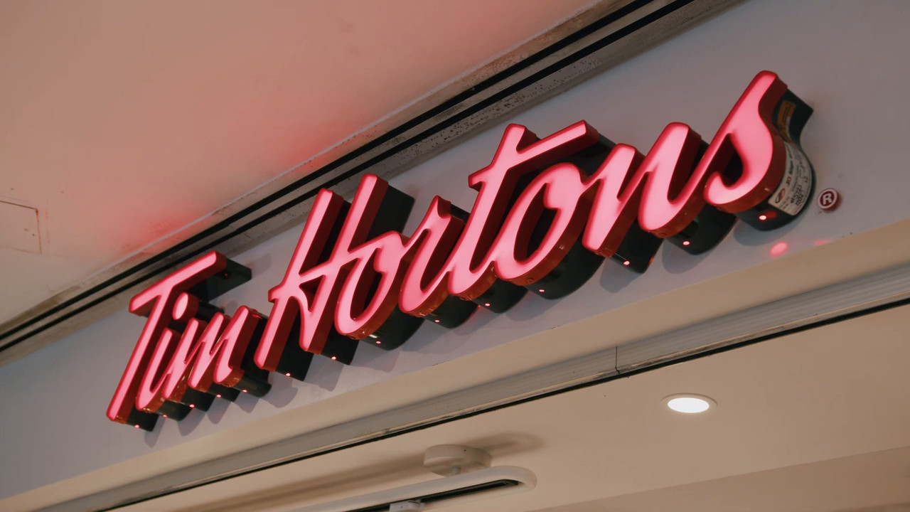 Illuminated Tim Hortons sign above the finished storefront