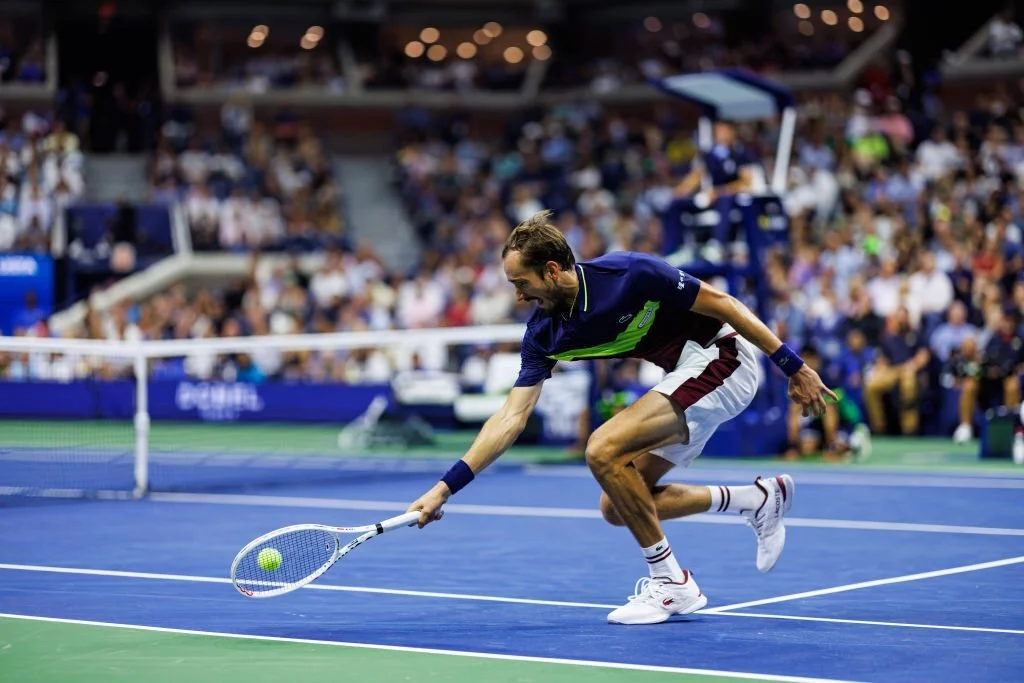 Daniil Medvedev hits a backhand against Carlos Alcaraz