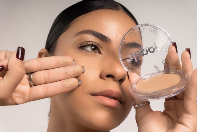 woman holding the right  foundation formula according to her skin typr so her foundation looks smooth and non-patchy 