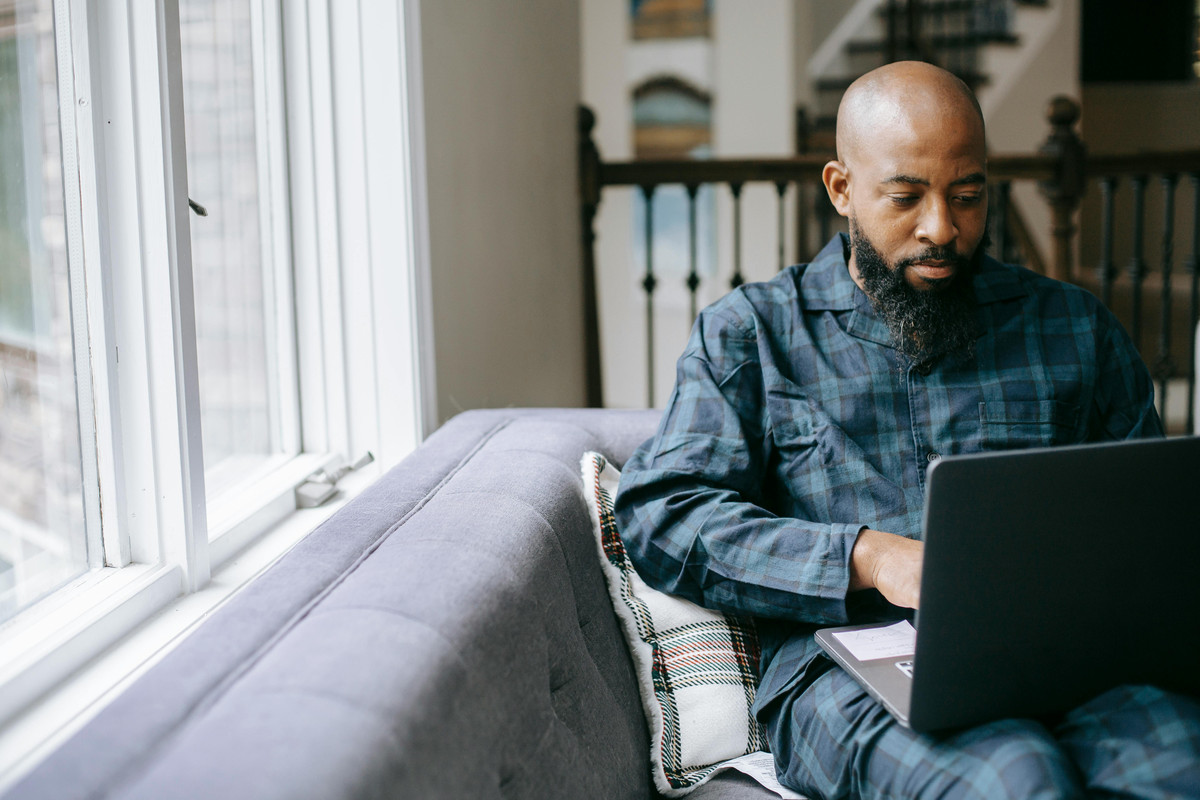Professional in serviced apartment working on laptop