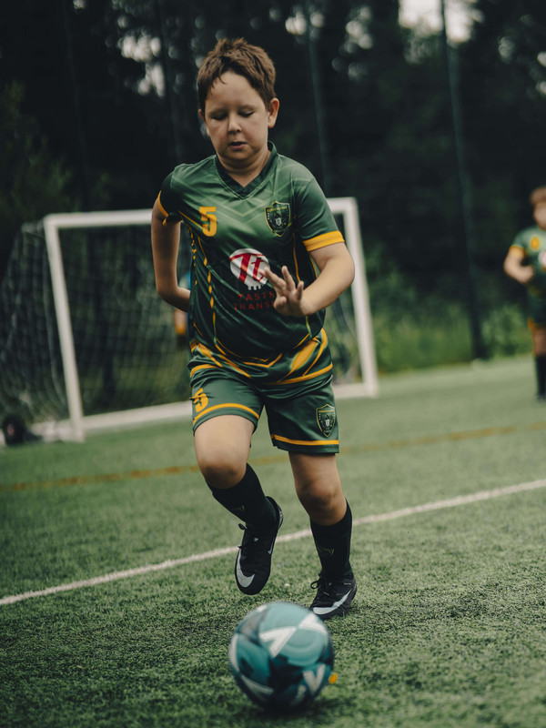 Young player dribbling during a Constantine Football Club training session in North West London
