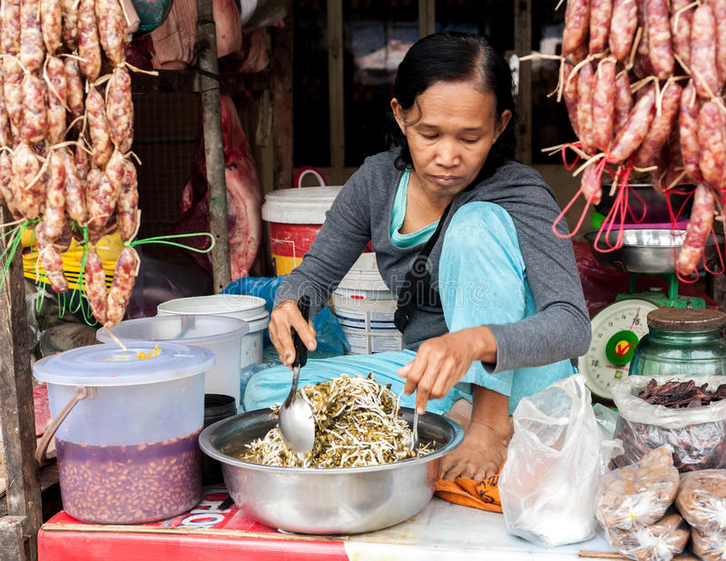 old lady selling street food at a local market near Siam Reap