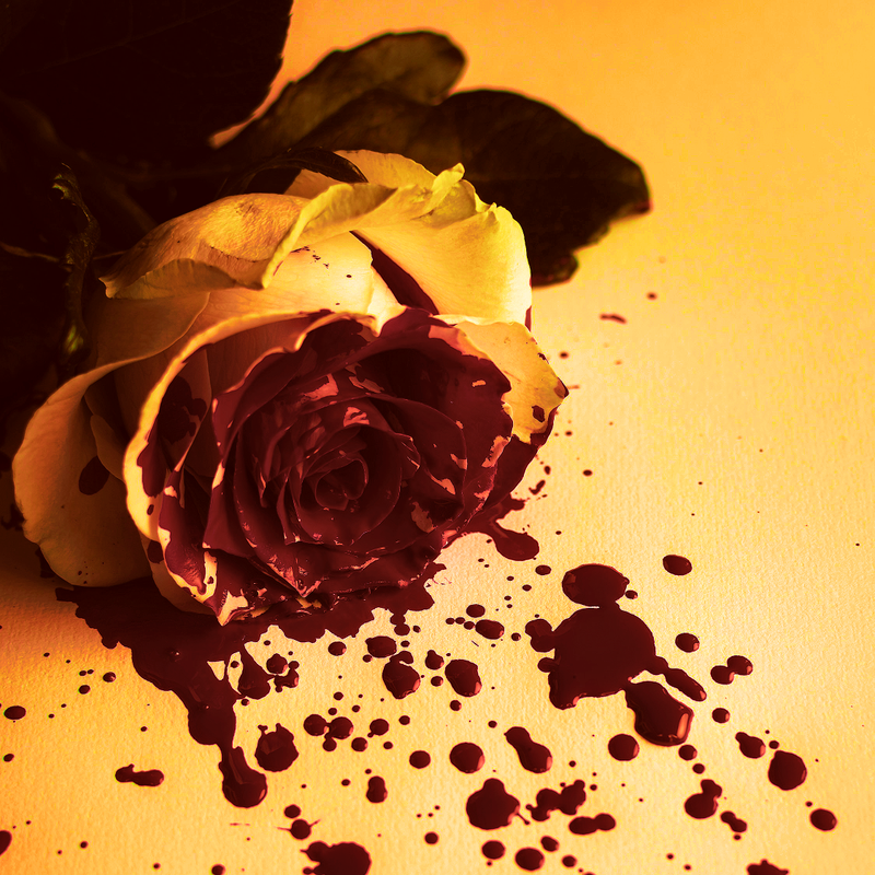 A golden rose covered in dark red ink (?)