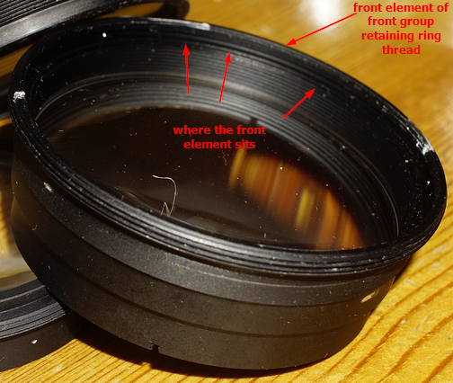  The outer retaining ring pulls it all out, the inner retaining ring is for the front element. Guess which one I started with?