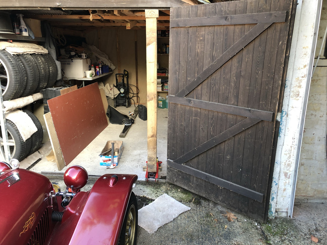 Jack supporting wooden garage.