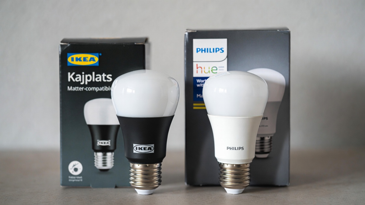 Matter-compatible smart bulbs from IKEA Kajplats and Philips Hue displayed with their packaging in 2026