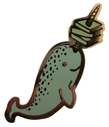 an enamel pin of a light blue narwhal with three books skewered on its horn