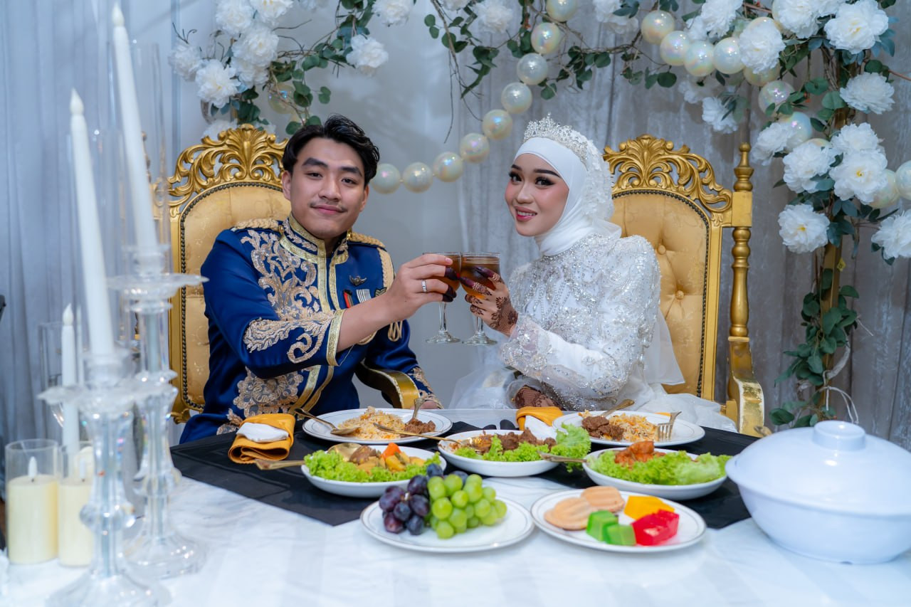 Pasangan pengantin menikmati hidangan