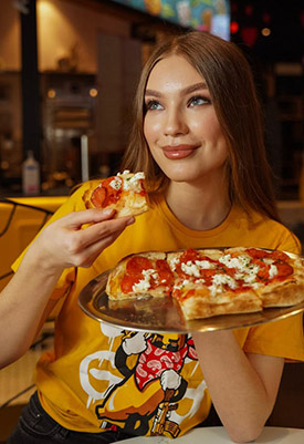 A girl eating pizza