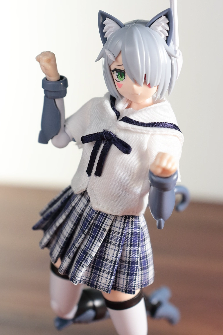 A front view of “Variable Fighter Girls” Kairos girl wearing a 1/12 White Collar Check Sailor Uniform Set in blue