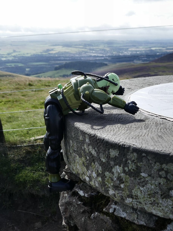 Green Robot climbing the stone marker post at Allermuir Hil. D9-D09658-BBA6-40-F3-9-BC0-481-B0-F032-ADB