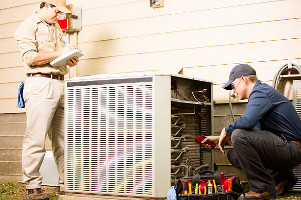 HVAC maintenance technician performing seasonal tune-up