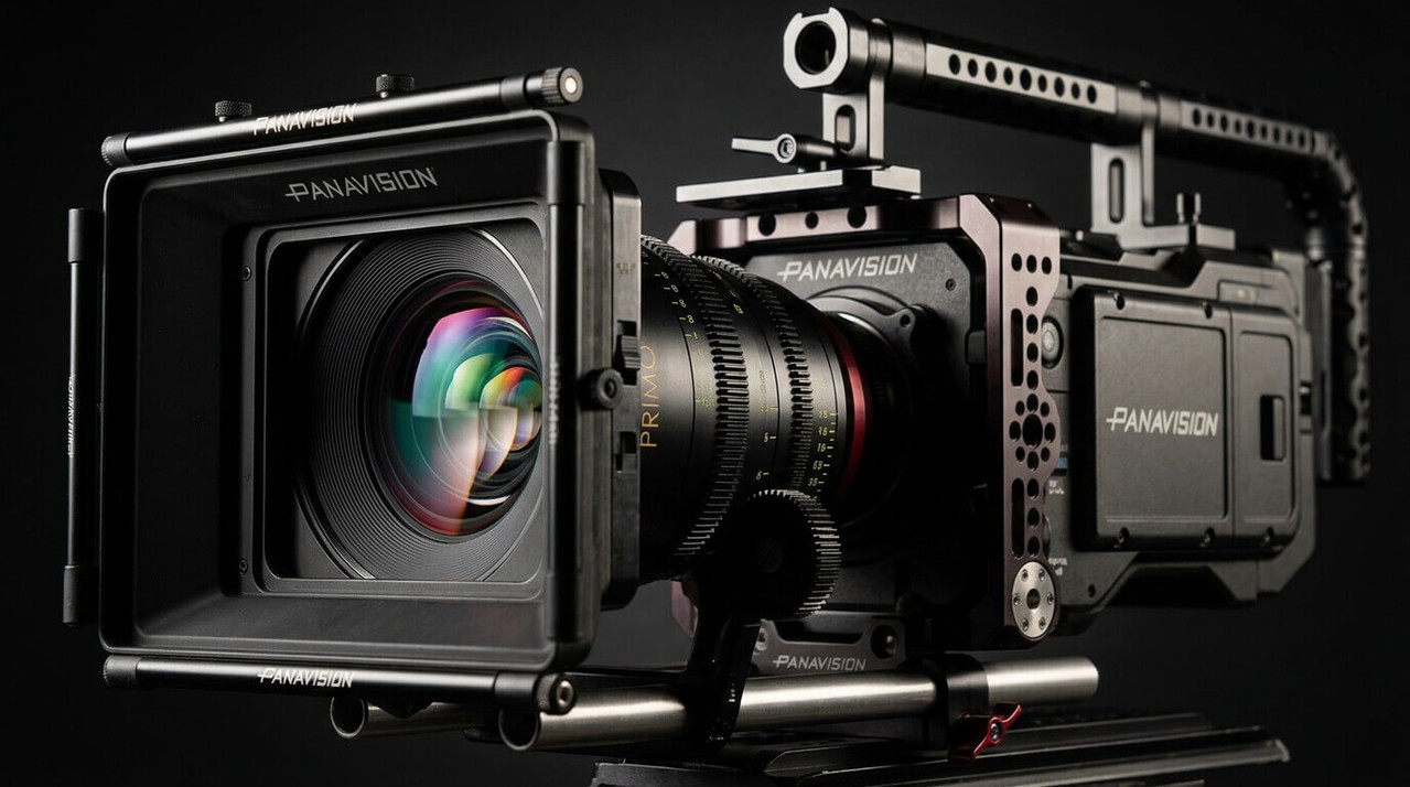 A detailed, professional black Panavision cinema camera rig with a complex modular cage, a large matte box with adjustable flags, and a prominent lens labeled 
