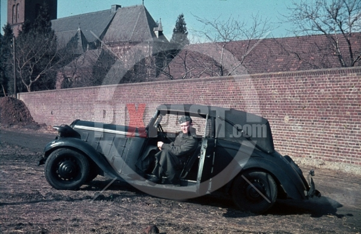 Wehrmacht soldier with car in Niederaußem, Germa