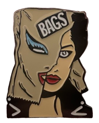 an enamel alice bag pin with a woman who has a bag over her head, except the bag is ripped down the middle so that you can see the right half of her head-- her long black hair and red lips. on the bag side, blue eyeliner and black lips are painted on, with a black sticker w/ white text that says 'BAGS' on it
