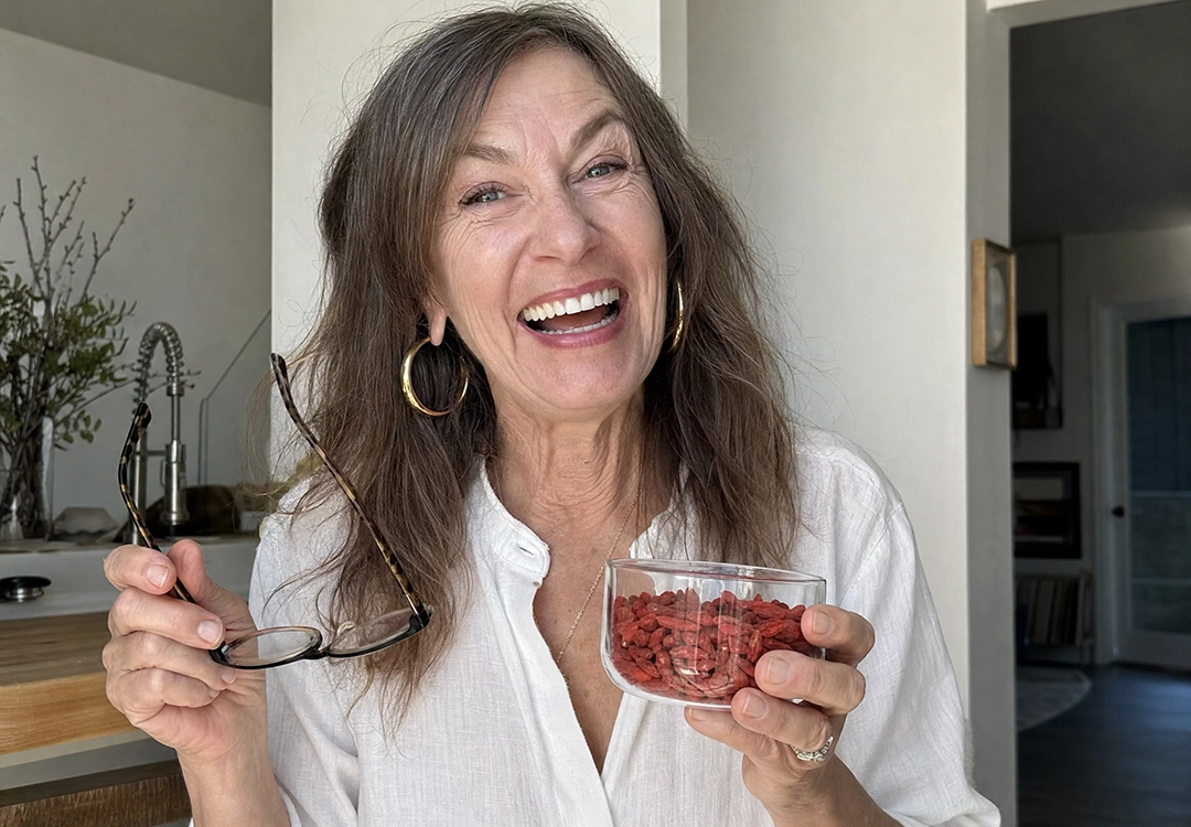 Organic dried goji berries steeping in a glass of hot water