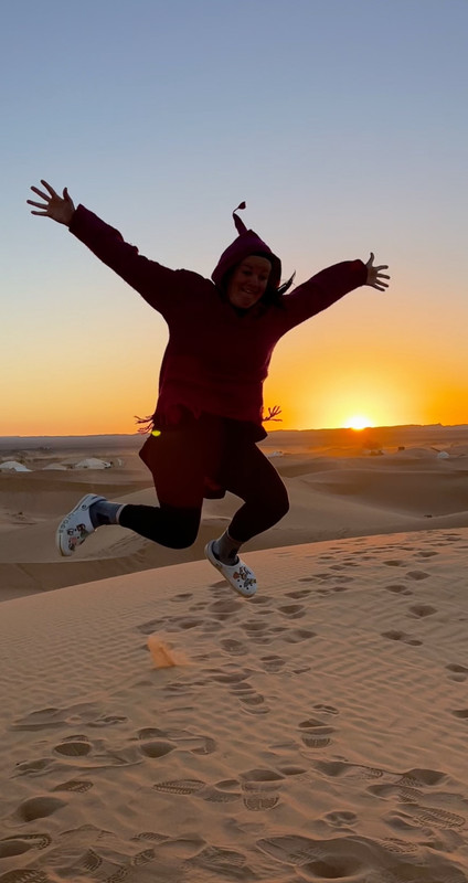 A silhouette jumping against a desert sunset