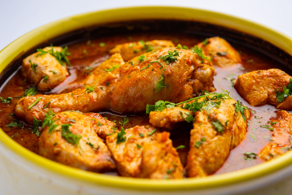 Pakistani red chicken curry with coriander garnish | سرخ چکن کری