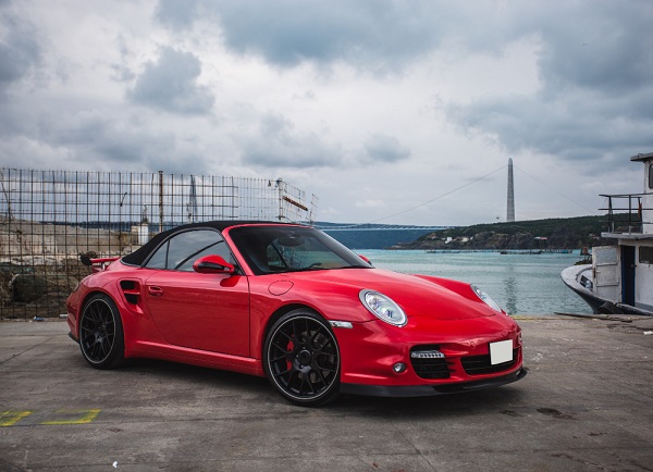 Red mini coupe parked port front view ship seaside