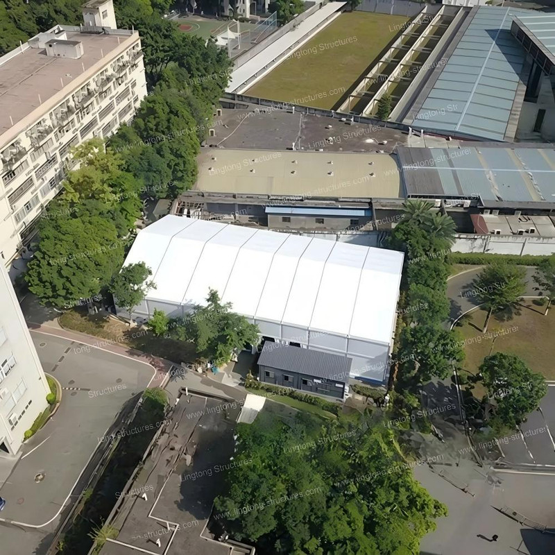 Aerial view of sports court tent installed in park setting for community sports activities