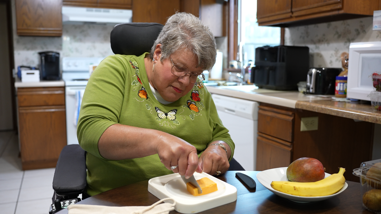 A smiling child using the Holstead meal prep tool