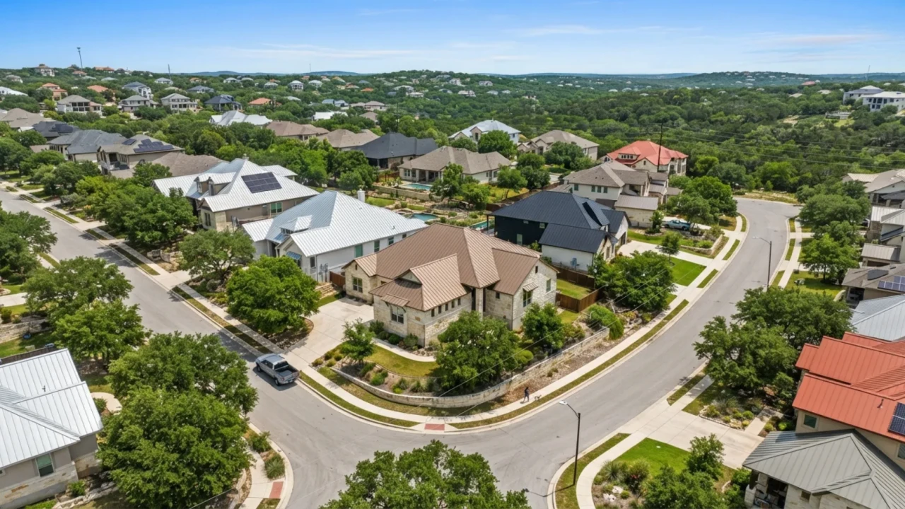 Aerial view of a San Antonio neighborhood featuring multiple homes with metal roofs in various styles and colors