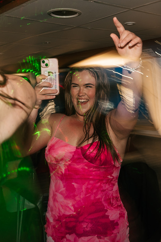 A vibrant, energetic dance floor at a student ball