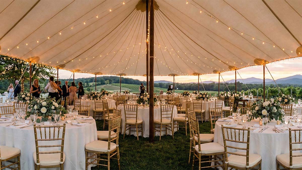 Роскошная свадьба под открытым небом с золотыми стульями Кьявари, круглыми столами и теплым вечерним освещением.