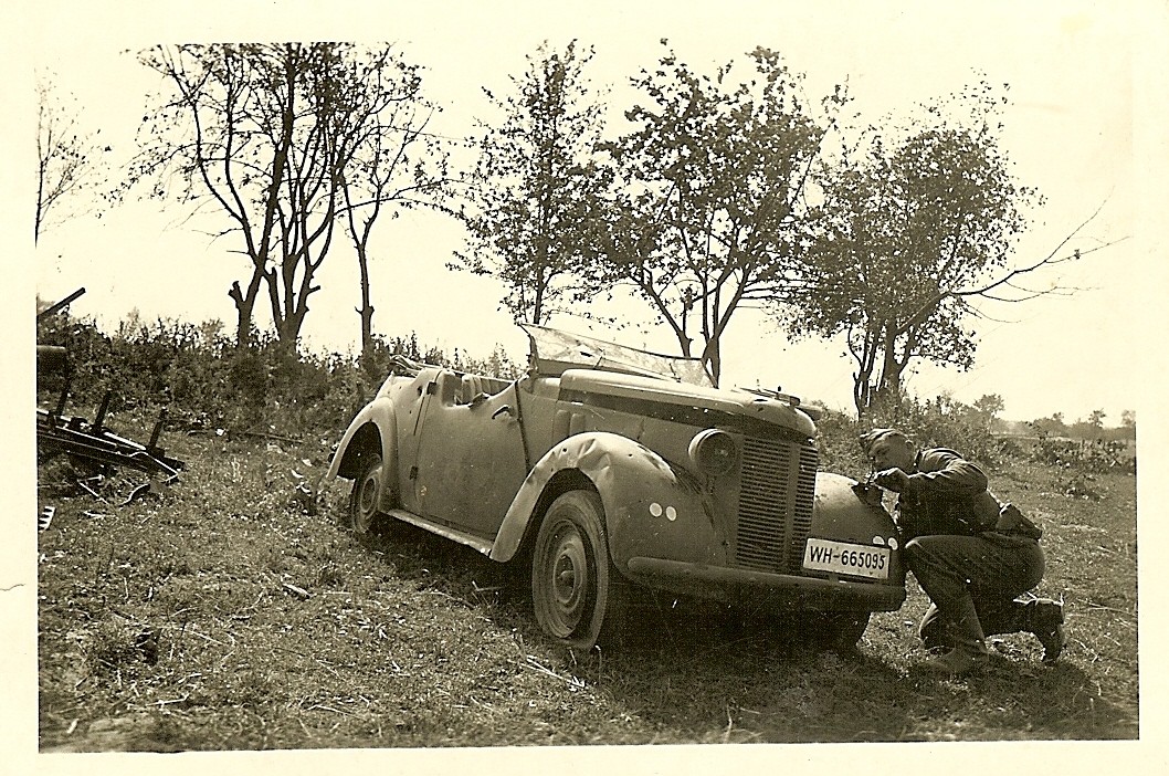 Wehrmacht Soldier Checking Shrapnel Damage on Opel Staff Car (WH-665095)!