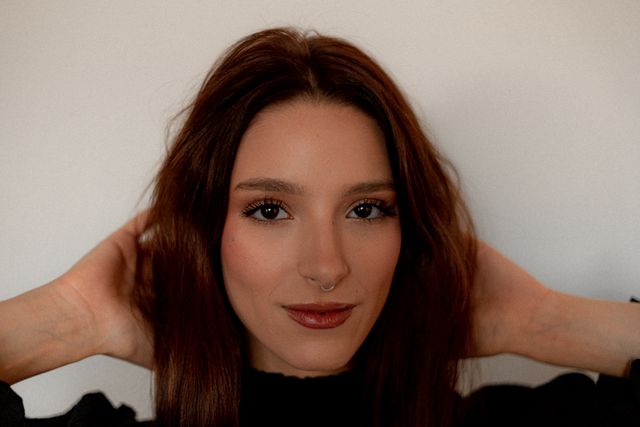 a woman wearing warm tone, brown fall makeup look 