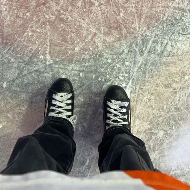 skates on ice taken from the point of view of the photographer