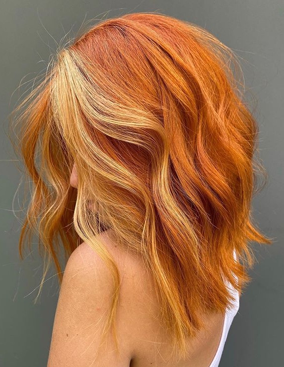 Golden melon color on strong wavy hair of medium length