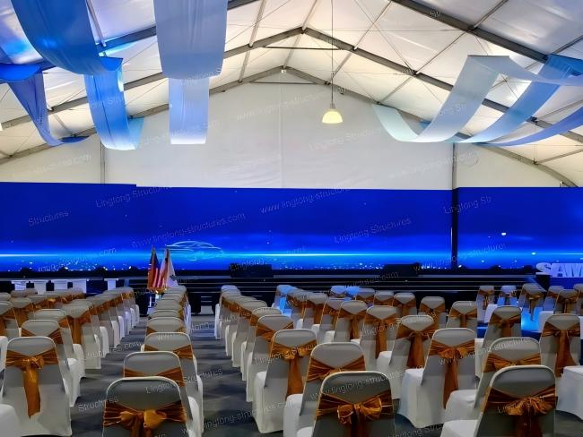 Beach wedding tent setup with transparent side walls and ocean view