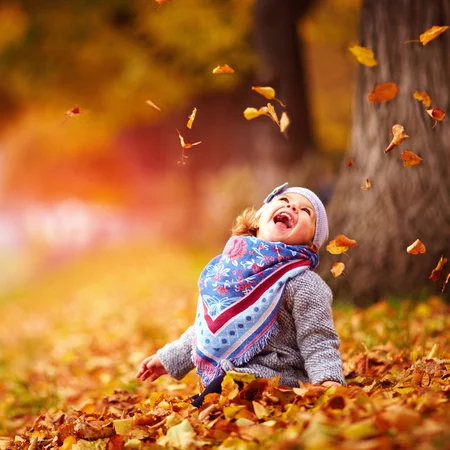 87095653-adorable-happy-baby-girl-catching-the-fallen-leaves-playing-in-the-autumn-park.webp