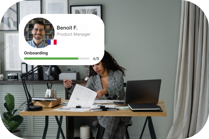 Two women coworkers smiling in warm toned office