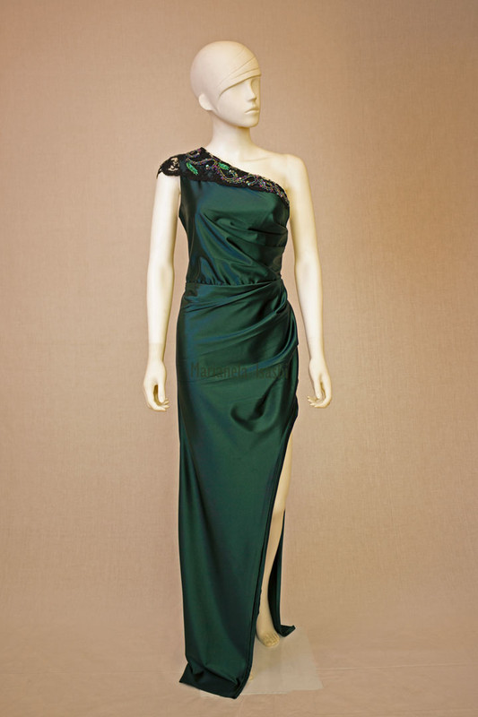 Long evening dress in satin bottle green with asymmetrical one-shoulder design and lace and rhinestone details.