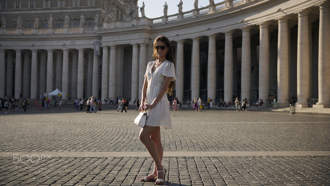 2Elegant woman in summer dress posing in iconic St. Peter Square, Vatican City