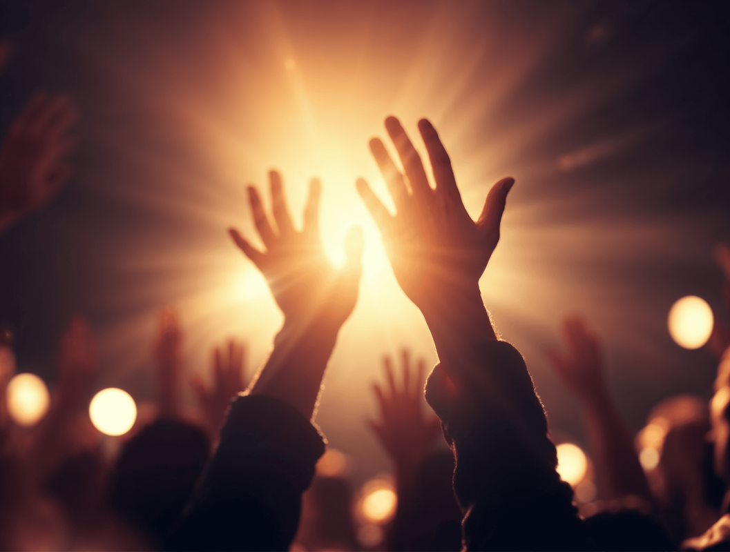 Hands raised toward light symbolizing experiencing God in worship.