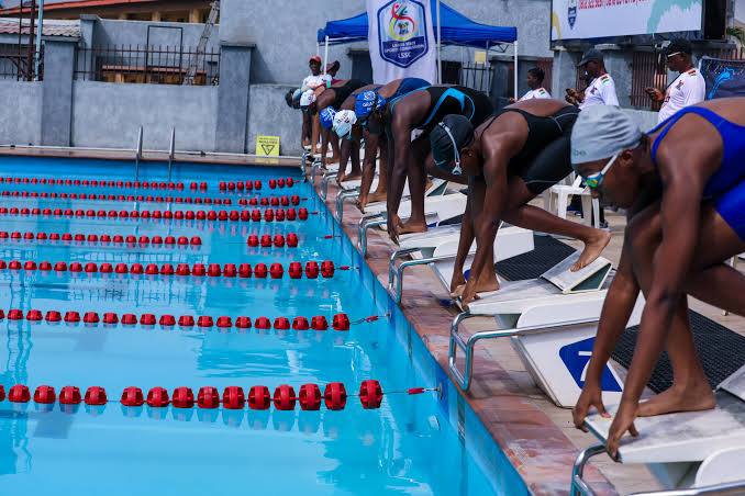 Black adult swimming in pool