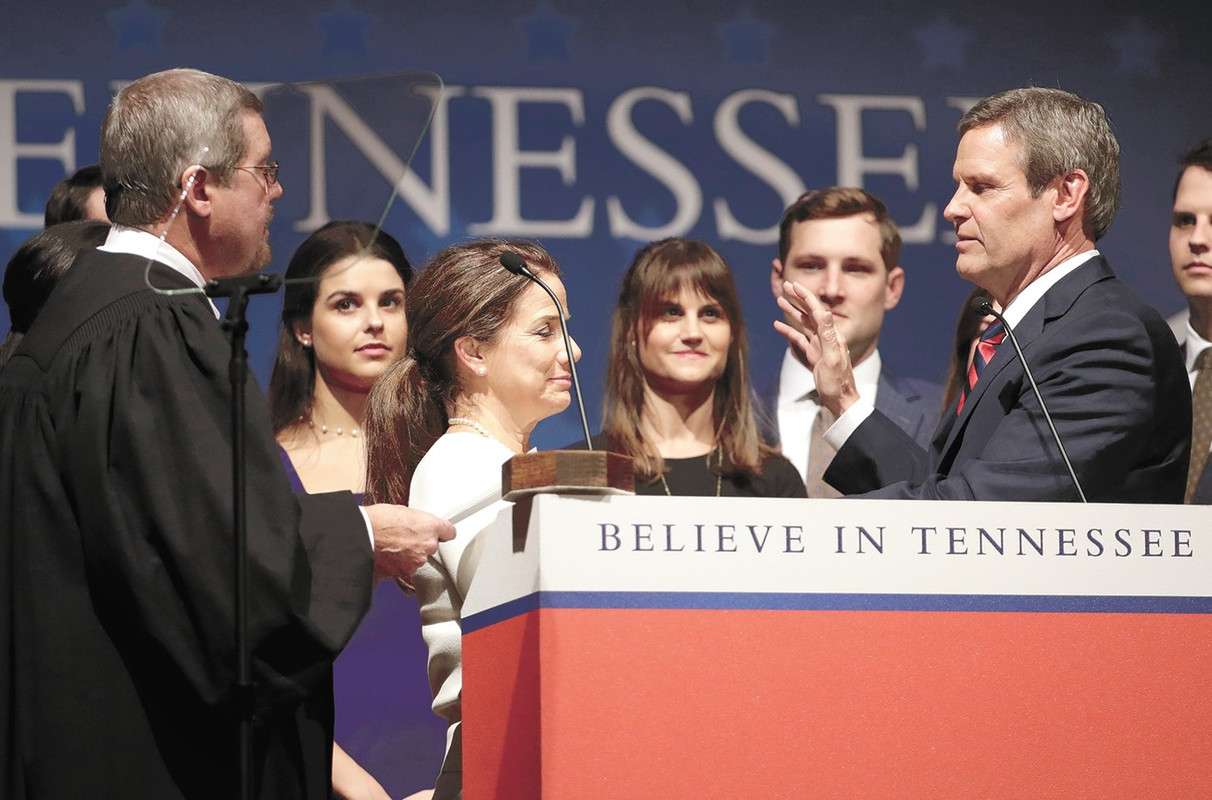 Bill Lee is sworn in as the 50th governor of Tennessee by Supreme Court Chief Justice Jeffrey Bivins as Maria Lee holds the Bible during the inauguration at War Memorial Auditorium in Nashville, Tenn., Saturday, Jan. 19, 2019.