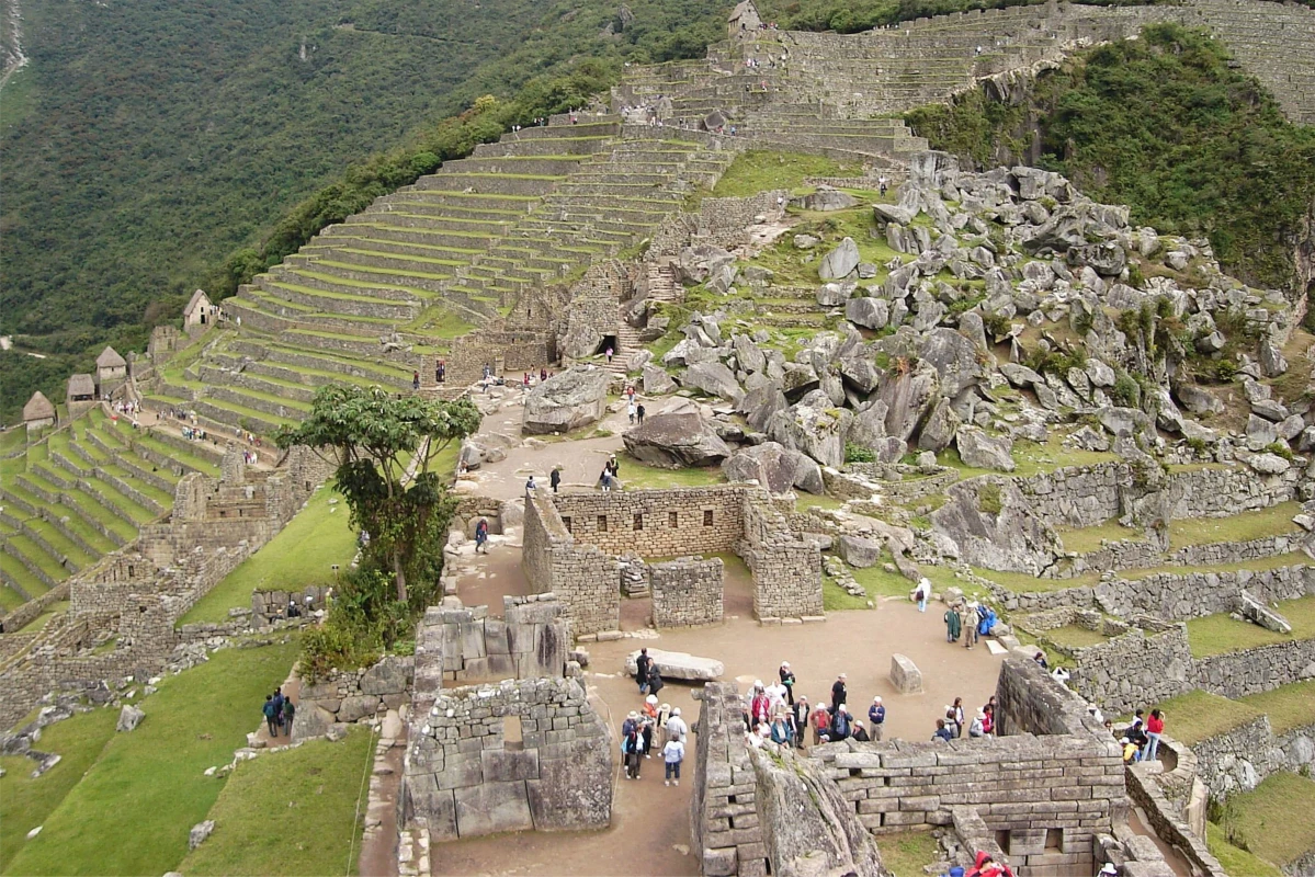 Visitors at Machu Picchu - Exploring the Ancient Inca Terraces Tourists exploring the terraces and ruins of Machu Picchu, Peru